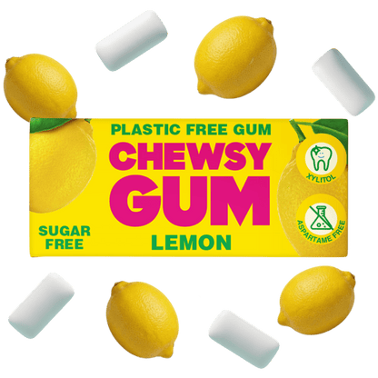 Lemon-flavored chewy gum packaging shown on a white background, surrounded by several white cylindrical gum pieces and whole lemons. The box reads 'CHEWSY GUM' with 'LEMON' below, plus 'PLASTIC FREE GUM', 'SUGAR FREE', and icons for aloe, fluoride-free, and aspartame-free.
