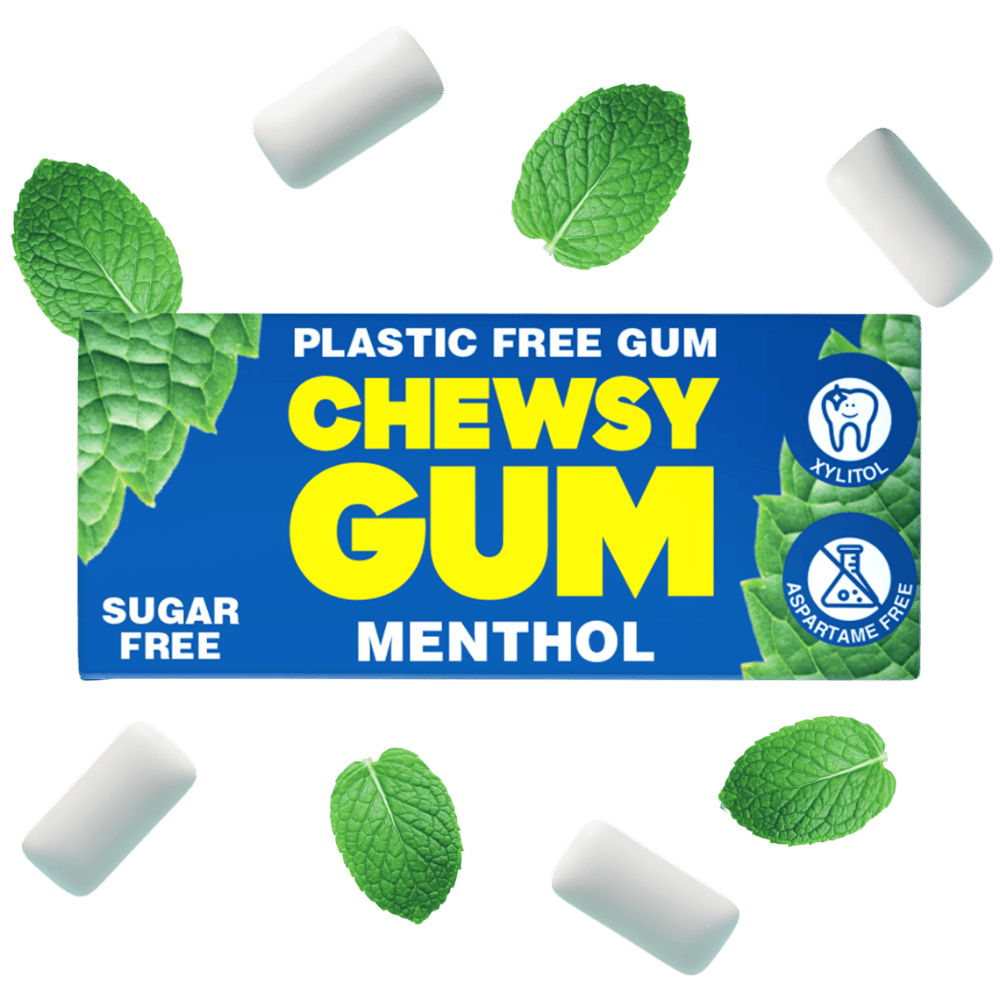 A pack of Chewsy Gum Menthol sugar-free plastic-free gum, shown with several white gum pieces and fresh green mint leaves floating around it on a solid white background.