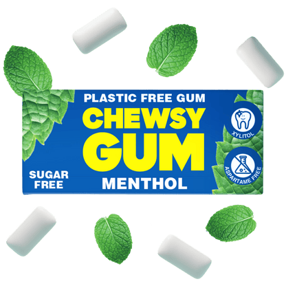 A pack of Chewsy Gum Menthol sugar-free plastic-free gum, shown with several white gum pieces and fresh green mint leaves floating around it on a solid white background.