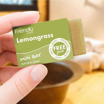 Hand holding a Friendly Soap lemongrass mini bar with a blurred background