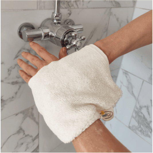 Person with a white towel wrapped around their wrist in a bathroom setting