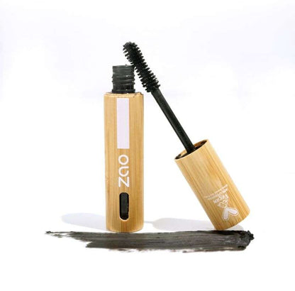 Open tube and brush wand of Daring Volume Mascara ORGANIC (7ml) with black mascara swatch on white background