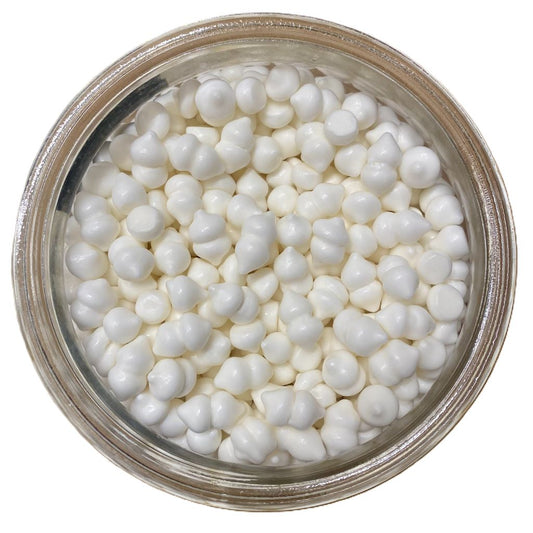 Jar filled with small meringues on a white background
