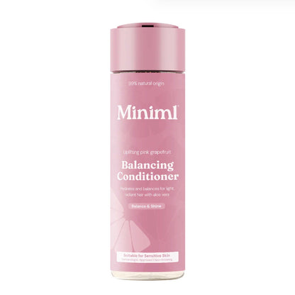 A bottle of Miniml Balancing Conditioner in light pink grapefruit scent, featuring a dusty pink bottle with white text and a matching pink cap, set against a plain white background.