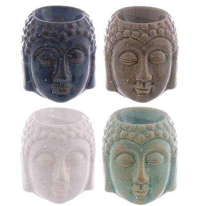 Four ceramic Buddha face wax melters in different colours on a white background