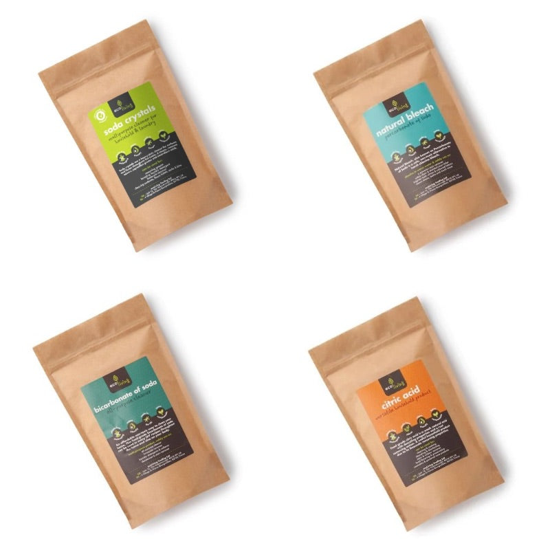 Four brown paper pouches labeled with natural cleaning ingredients in the CLEANING Powders Bundle from The Village Refill.