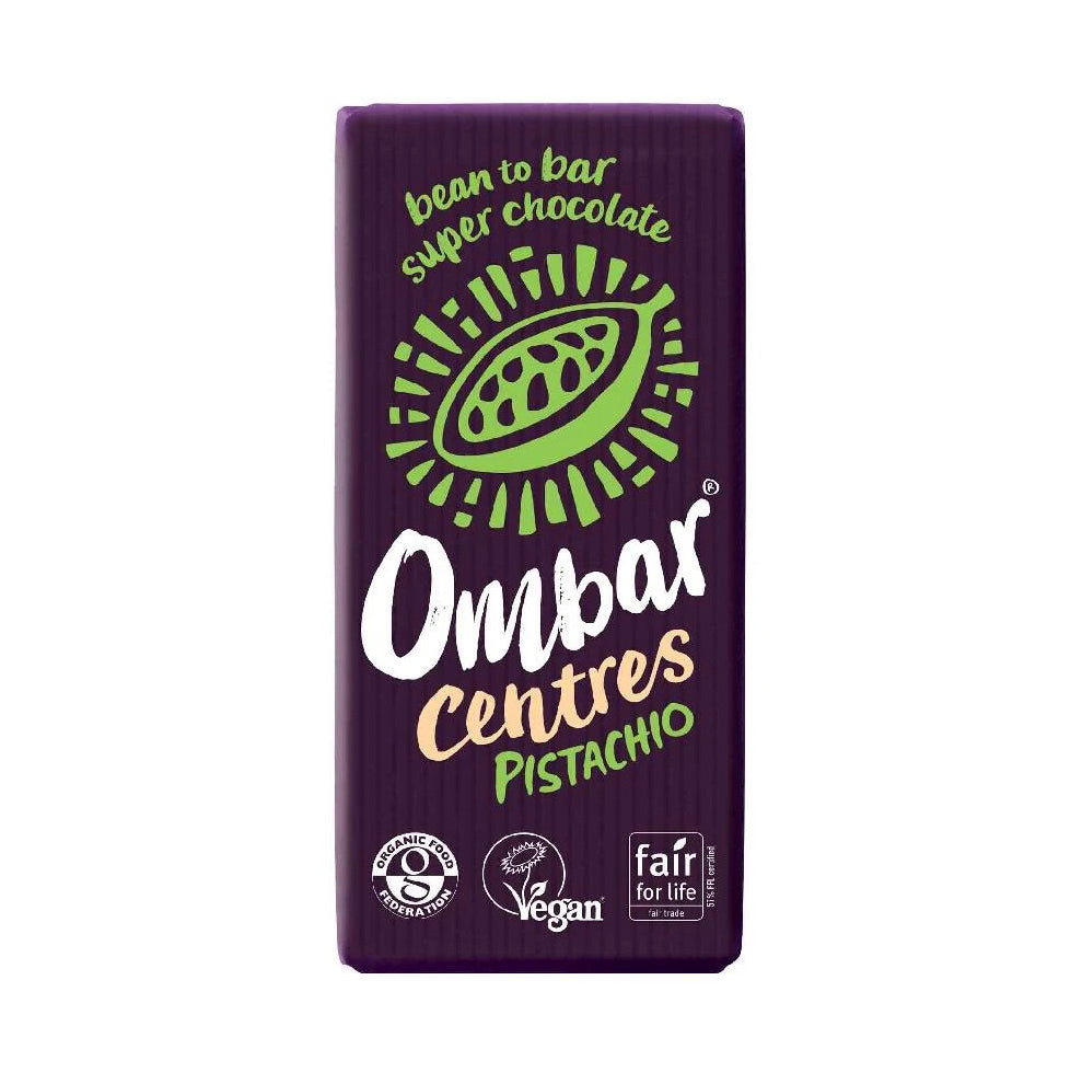 A packaged Ombar Centres Pistachio bean to bar super chocolate bar, featuring a dark purple wrapper with a green pistachio illustration and white, green, and gold text.