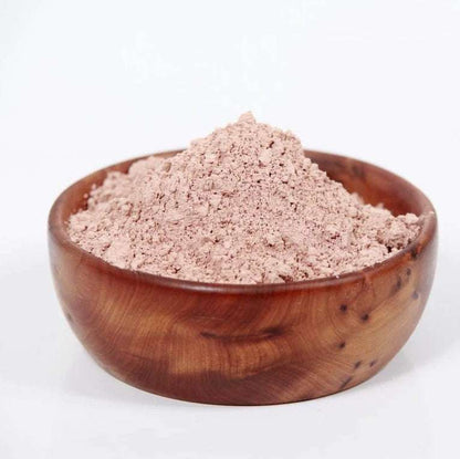 French Pink Clay powder in a wooden bowl, natural skincare ingredient, cruelty-free and sustainable product.