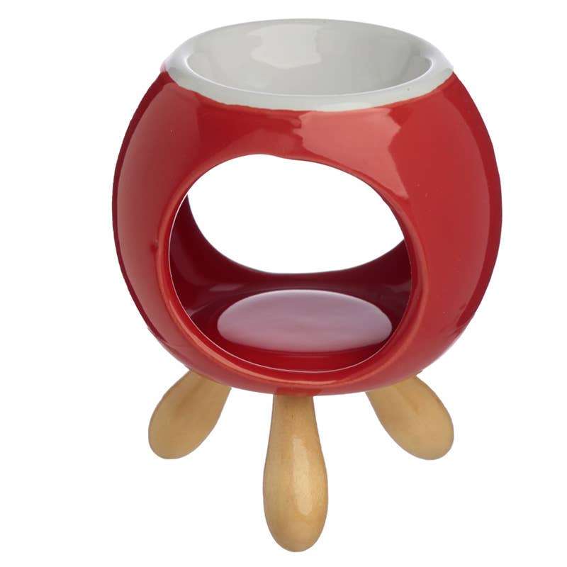 Red ceramic melter with wooden legs on a white background