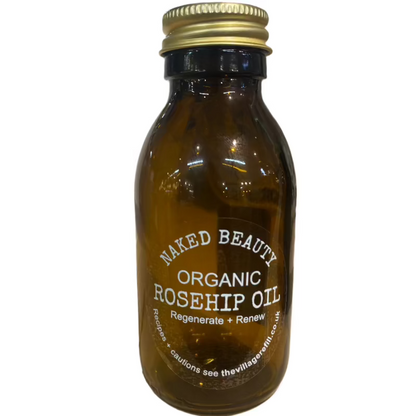 Amber glass bottle of Rosehip Seed Oil with gold cap labeled organic for natural skincare and renewal benefits