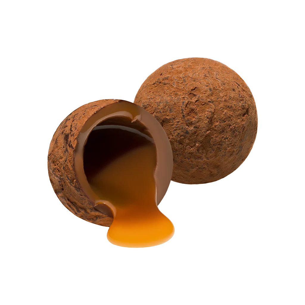 Chocolate truffle with a shell that has been partially eaten, revealing a rich chocolate filling.