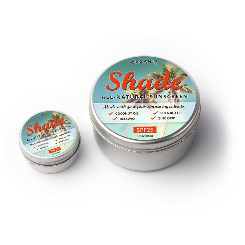 Two tins of Shade all-natural sunscreen on a white background
