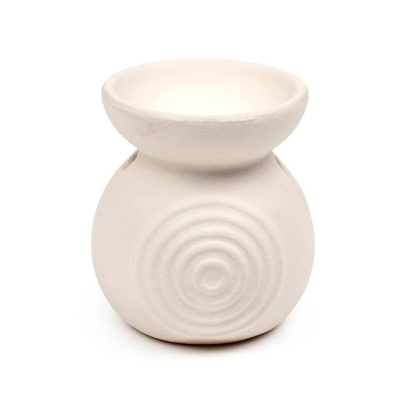White ceramic oil burner with circular design on a white background