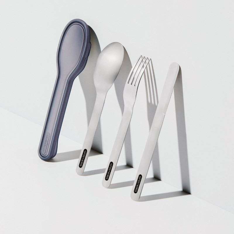 A set of stainless steel portable cutlery, including a spoon, fork, and knife, displayed in a nesting arrangement with a light gray case in the background.