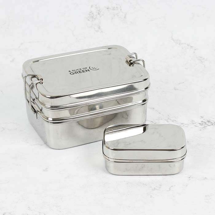 Two metallic lunch boxes on a light gray background
