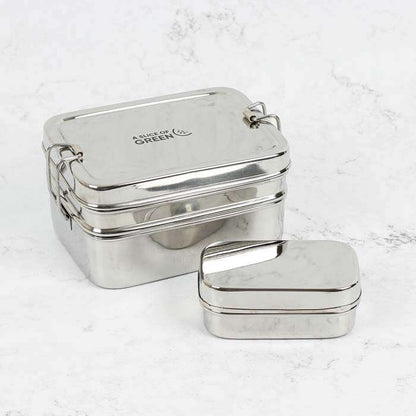 Two metallic lunch boxes on a light gray background