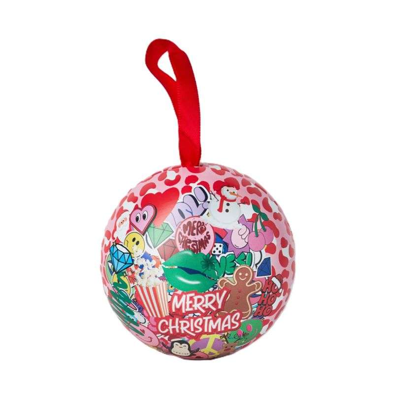 Decorative Christmas ball with colourful stickers and a red string on a white background