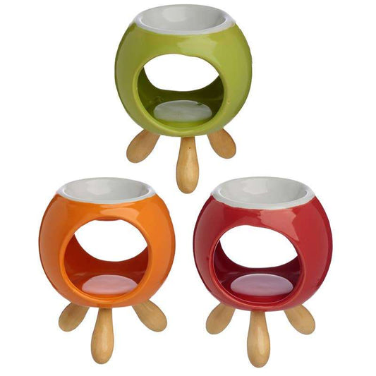 Set of three Round Ceramic Oil Burner/Wax Melter with Feet in green, orange, and red, perfect for sustainable homes.
