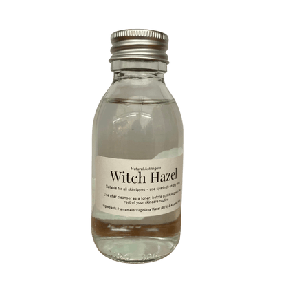 Clear glass bottle with metal cap containing Witch Hazel natural astringent for skincare use