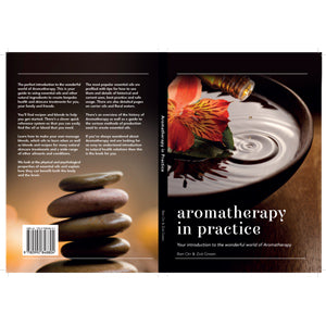 Book cover of 'Aromatherapy in Practice' with stones and a flower on a plate.