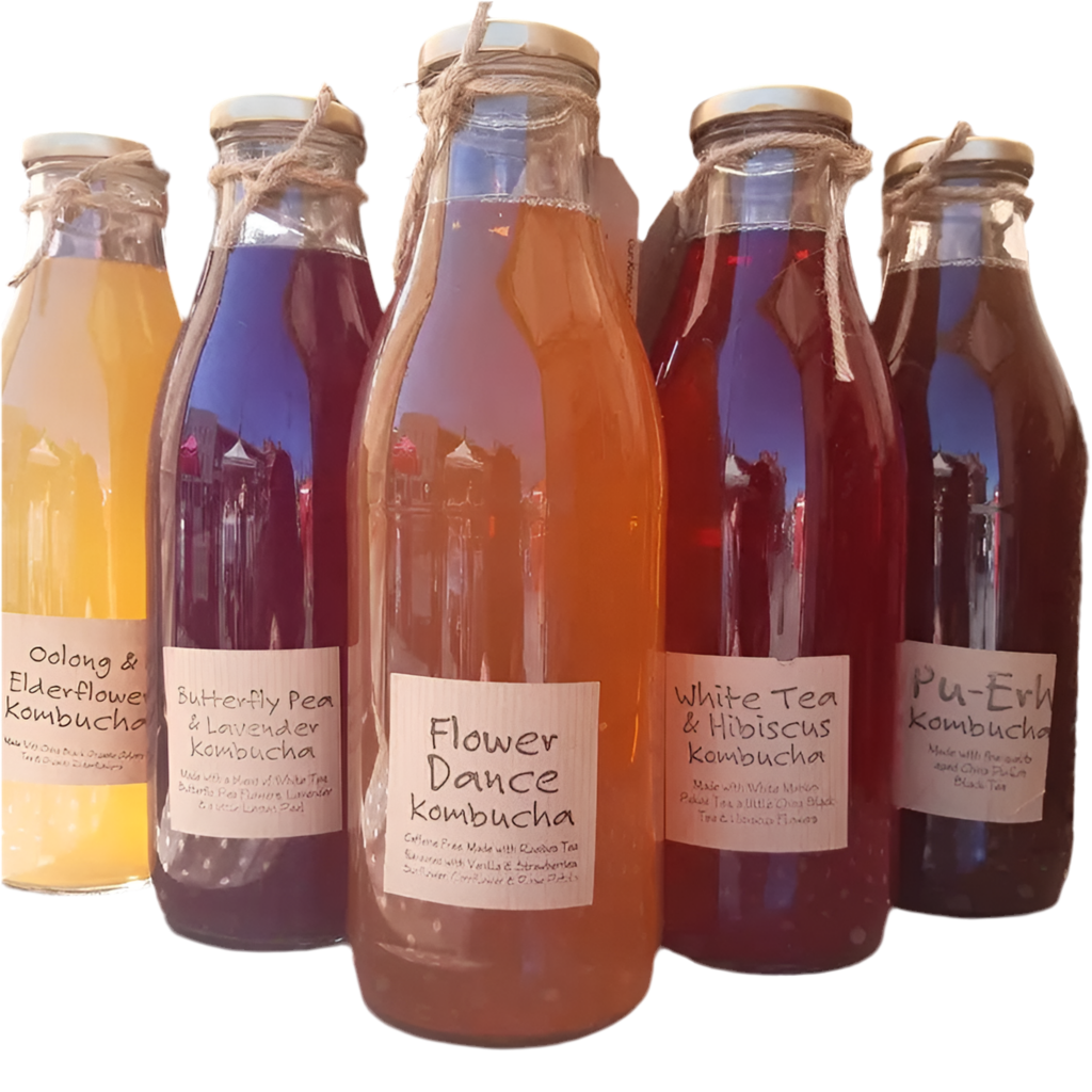 Variety of colorful Kombucha bottles with natural flavors in reusable glass containers at a refill shop