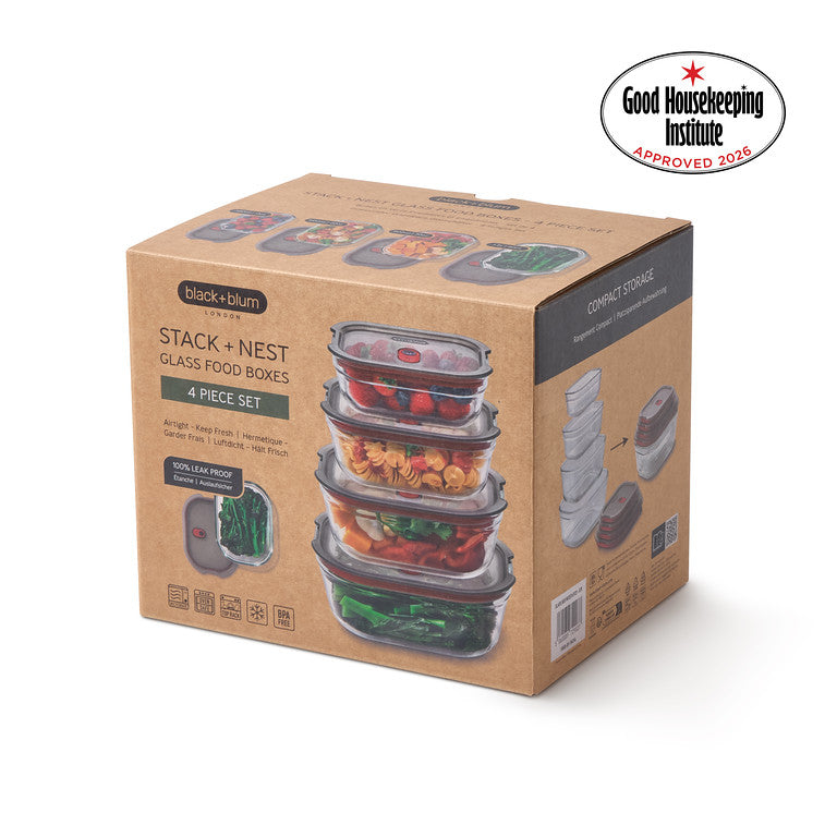 A 4-piece stack and nest glass food storage box set in its original brown kraft paper packaging, featuring a Good Housekeeping Institute Approved 2026 badge in the top right corner.