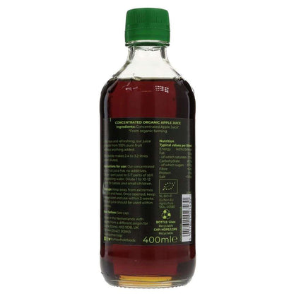 Bottle of concentrated organic apple juice with a green cap on a white background