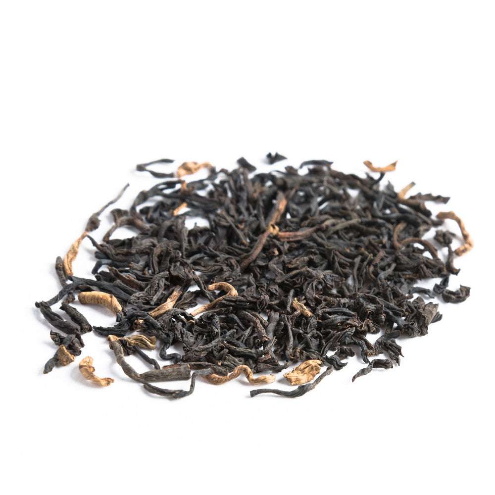 Dry black tea leaves on a white background