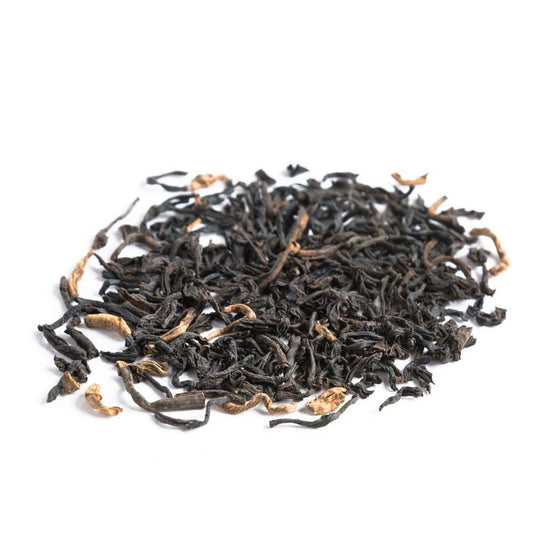 Dry black tea leaves on a white background