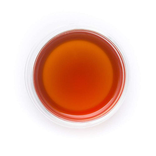 Tea in a clear glass cup on a white background