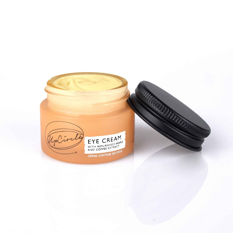 Eye cream jar with black lid on a white background