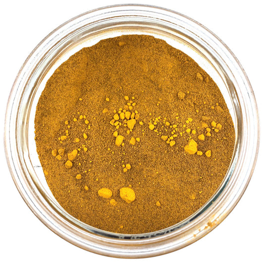Jar of turmeric latte on a white background