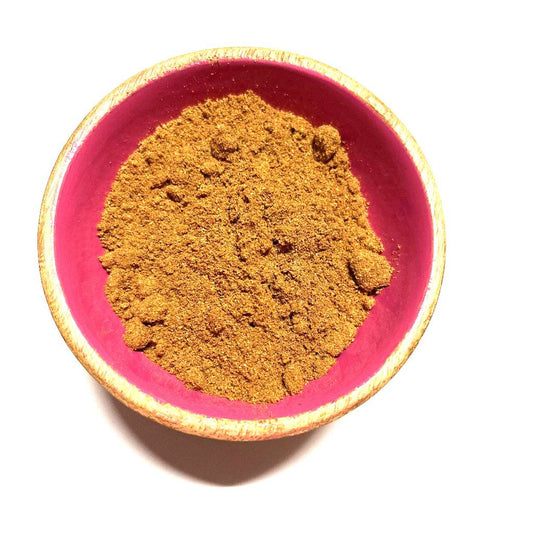 Red bowl filled with ground mixed spice