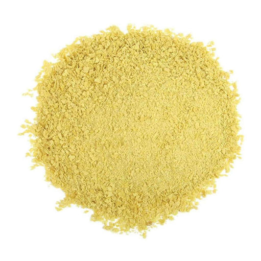 Pile of nutritional yeast on a white background