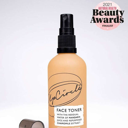 UpCircle face toner bottle with a 2021 Natural Health Beauty Awards finalist badge on a light purple background.