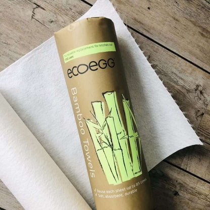 Reusable Bamboo Kitchen Towels (20 sheets) rolled with eco-friendly packaging on a wooden surface and white towel.
